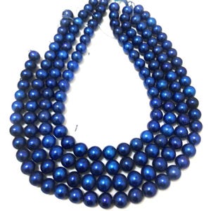 Puede incluir: Varias hebras de cuentas azul oscuro, probablemente para joyer&iacute;a. Las cuentas son redondas y tienen un acabado brillante. La disposici&oacute;n muestra m&uacute;ltiples hebras, posiblemente para collares o pulseras.