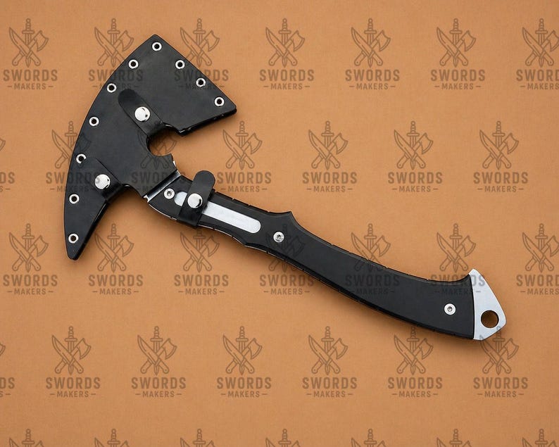 May include: A black axe with a curved blade and handle. The axe head is made of black metal and has a curved blade. The handle is also black and has a silver accent. The text "SWORDS -MAKERS-" is repeated across the background.