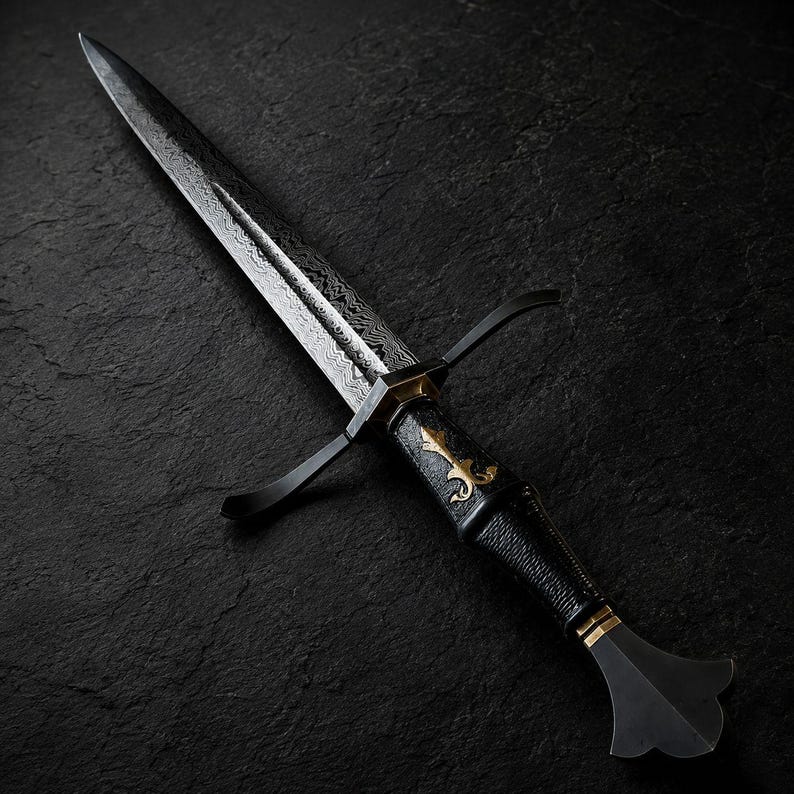 May include: A double-edged dagger featuring a patterned Damascus steel blade, a black textured grip with gold-coloured decorative inlay, a black crossguard, and a flared pommel. The blade displays a distinct wavy layered metal texture.