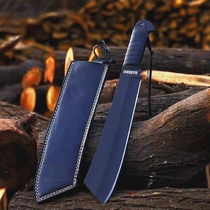 May include: A black machete with a blue sheath, set against a backdrop of logs. The machete features a dark blue handle, with the word "RAMBO" on the blade. The sheath is made of blue leather with white stitching.