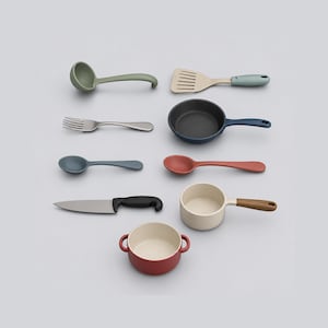 May include: A collection of toy kitchenware including a sage green ladle, a beige and blue spatula, a silver fork, a dark blue frying pan, a blue spoon, a red spoon, a silver knife with a black handle, a beige saucepan, and a red two-handled pot.