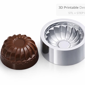 May include: A 3D printable dessert mold and a chocolate dessert. The mold is silver and cylindrical with a fluted interior. The dessert is dome-shaped, dark brown, and has a ribbed design. Text on the image reads: 3D Printable Dessert Mold, STL + STEP Files.