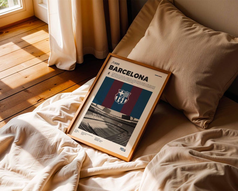 May include: A framed poster featuring the FC Barcelona logo and team colors of blue, maroon, and red. The poster includes the text "/1899 BARCELONA" and a black and white image of a stadium. The frame is made of wood.