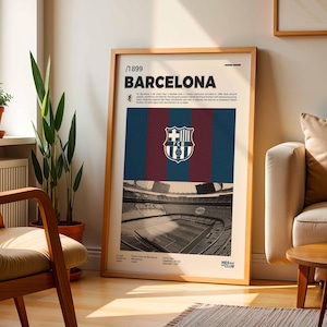 May include: A framed poster featuring the FC Barcelona crest and stadium imagery. The poster has a wooden frame and includes the text "/1899 BARCELONA". The design incorporates the team's colors: blue, maroon, and gold.