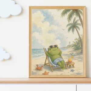 May include: A framed watercolor print featuring a green frog wearing sunglasses, relaxing in a blue and white striped beach chair on a sandy beach. The scene includes palm trees, a small lighthouse, a drink with a straw, a crab, and starfish.