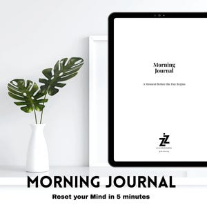 May include: A digital tablet displaying the words "Morning Journal" and "A Moment Before the Day Begins." A white vase with green leaves sits to the left. The text "MORNING JOURNAL" and "Reset your Mind in 5 minutes" are at the bottom.