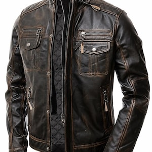 May include: A dark brown distressed leather jacket featuring a quilted stand-up collar, multiple zippered chest and side pockets, snap button closures, and a black quilted interior lining. The jacket has long sleeves with reinforced stitching.
