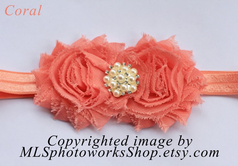 May include: Coral colored fabric flower headband with a pearl and rhinestone embellishment.