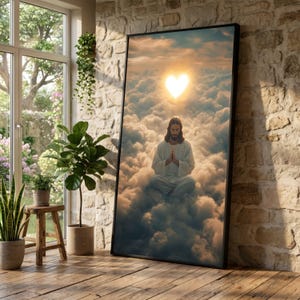 May include: A framed art print depicts a serene scene of a figure in white robes meditating amidst fluffy clouds. A heart-shaped light shines above. The artwork is set against a backdrop of a cloudy sky, creating a spiritual and peaceful atmosphere.