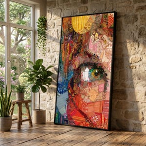 May include: A large rectangular framed wall art piece featuring a vibrant mosaic-style collage of various fabric patterns in shades of red, orange, yellow, blue, and pink, depicting a close-up portrait of a face with a prominent eye as the focal point.