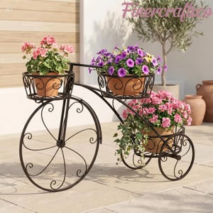 May include: A decorative, dark brown metal bicycle planter with three tiers, each holding a terracotta pot filled with vibrant flowers. The planter has a whimsical design with scrollwork details and is suitable for outdoor use.