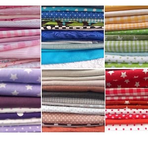 May include: A collection of folded fabric stacks in various colors and patterns. The fabrics include pinks, blues, greens, purples, and reds. Some fabrics have polka dots, stars, or gingham patterns. The image showcases a variety of textiles suitable for sewing or crafting projects.