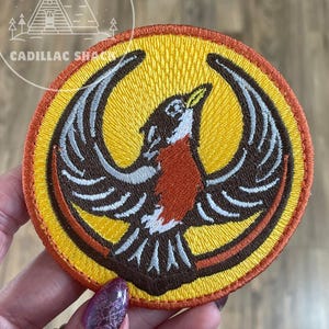 May include: A set of three ceramic mugs with a speckled, matte finish. The mugs are in shades of cream, gray, and black. Each mug has a simple, minimalist design, suitable for coffee or tea.