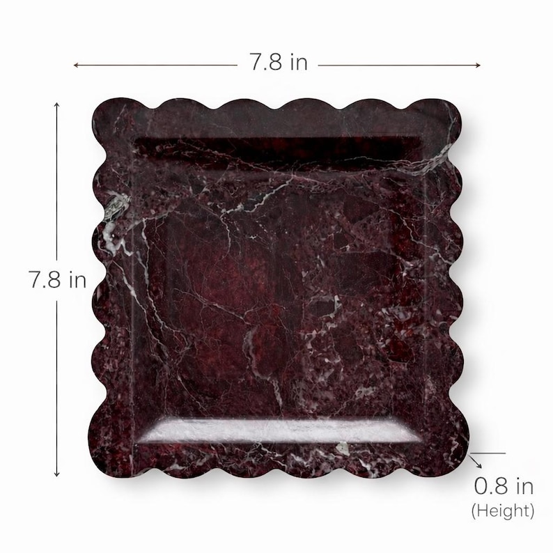 May include: A square serving tray with a scalloped edge. The tray measures 19.8 cm by 19.8 cm and is 2 cm high. It has a dark red marble pattern with white veining. Suitable for serving food or displaying items.