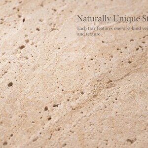 May include: Close-up of a light beige stone surface with a unique texture and veining. The image includes the text "Naturally Unique Stone" and "Each tray features one-of-a-kind veining and texture."
