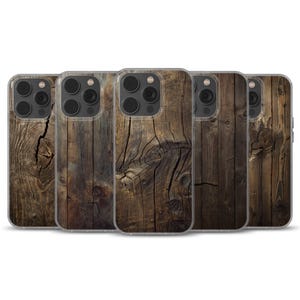 May include: Five phone cases with a distressed wood effect. The cases show a detailed pattern of brown and tan wood with visible knots and cracks, creating a rustic look. The cases are designed to fit a smartphone.