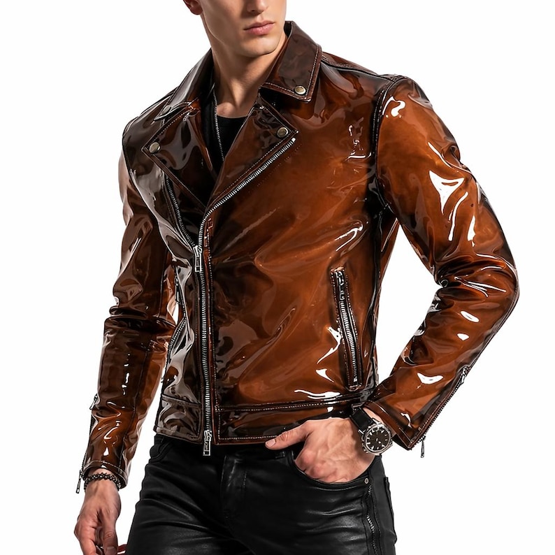 May include: A brown, glossy, motorcycle-style jacket with a zipper closure, lapel collar, and multiple zippered pockets. The jacket has long sleeves and a shiny, reflective finish. The model is wearing black pants and a watch.
