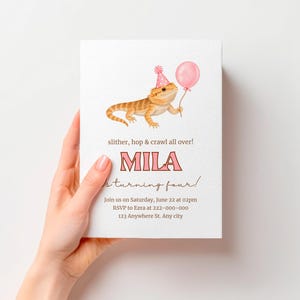 May include: A white birthday invitation card featuring an illustration of a bearded dragon wearing a pink polka-dot party hat and holding a pink balloon. The text reads: slither, hop & crawl all over! MILA is turning four! Join us on Saturday, June 22 at 02pm RSVP to Ezra at 222-000-000 123 Anywhere St. Any city.