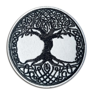 May include: A circular patch featuring a black and white embroidered design of the Tree of Life. The tree's branches and roots are intricately detailed within a circular border. The patch is suitable for sewing or ironing onto fabric.