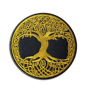 May include: A round, black patch featuring a gold-colored embroidered Tree of Life design. The tree's branches and roots are intricately woven with Celtic knotwork. The patch has a black border and is set against a white background.