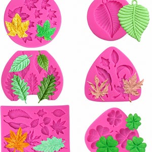 May include: A collection of six pink silicone molds featuring various leaf and clover shapes. The set includes circular, triangular, and rectangular molds with detailed impressions of maple, oak, and clover leaves, accompanied by finished leaf castings.