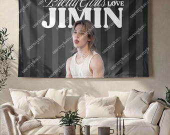 May include: A rectangular wall tapestry featuring a black and gray vertical striped background. The text Pretty Girls LOVE JIMIN is printed in white at the top. Below the text is a photographic portrait of a person with light brown hair.