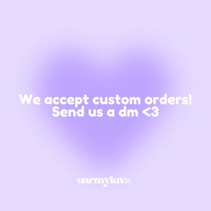 May include: A soft purple background with a heart-shaped gradient. White text reads "We accept custom orders! Send us a dm <3". The shop's logo, "warmyluv etsy shop", is at the bottom.