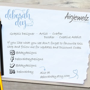 May include: A white sheet of paper with blue text that reads "deborah dey .co.uk" and "Ainjewelz PRINT-CUT-CREATE". The text also reads "Graphic Designer - Artist - Crafter - Doodler - Creative Addict". Below the text are social media icons and the text "If you like what you see don't forget to favourite this shop and follow me for updates and Discount Codes".