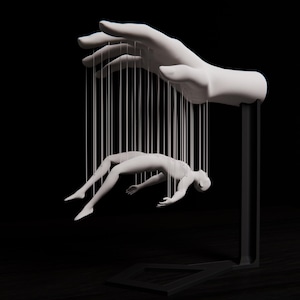 May include: A white sculpture of a hand holding a human figure suspended by strings. The hand and figure are set against a black background, creating a dramatic contrast. The artwork evokes themes of control and manipulation.