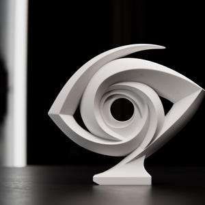 May include: A white abstract sculpture in the shape of an eye. The sculpture has a spiral design in the center and is set against a black background. The sculpture is made of a smooth, matte material.