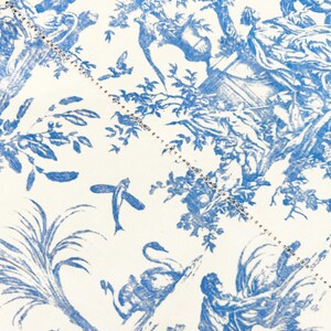 May include: Close-up of a fabric with a blue and white toile pattern. The design features classical figures, trees, birds, and other natural elements. A dotted line with small embellishments runs diagonally across the fabric.