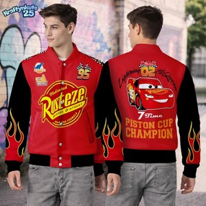 May include: Red and black bomber jacket featuring the "Rust-eze" logo and flame graphics. The jacket has a snap-button closure and the number "95" on the front. The back displays "Lightning McQueen" and "7 Time Piston Cup Champion" graphics.