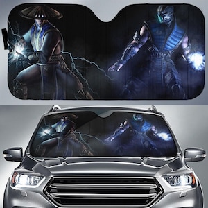 May include: Black car windshield sunshade featuring two characters from a video game. One character is wearing a hat and robe, with blue and white accents, and the other is in a blue and black outfit. Lightning bolts are visible.