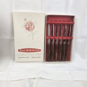 May include: A set of three ceramic vases in varying heights and shapes. The vases are glazed in a matte white finish, offering a minimalist aesthetic. The tallest vase is approximately 10 inches high.