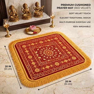 May include: A square red velvet prayer mat featuring a gold floral pattern and gold fringe trim. The mat measures 20 inches by 20 inches. Text on the image reads: PREMIUM CUSHIONED PRAYER MAT (RED VELVET), SOFT VELVET TOUCH, ELEGANT TRADITIONAL DESIGN, MULTI-PURPOSE EVERYDAY USE, 100% WASHABLE.