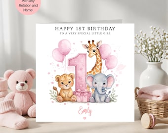 May include: A birthday card with the text "HAPPY 1ST BIRTHDAY TO A VERY SPECIAL LITTLE GIRL". The card features a pink number one, a giraffe, a lion cub, and an elephant. Pink balloons and the name "Emily" are also included.