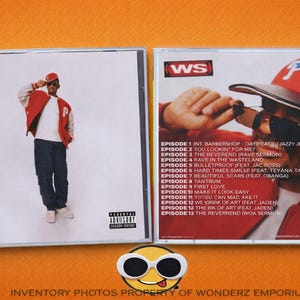 May include: CD case featuring a man in a red jacket and hat, with the text "WS" and "Parental Advisory". The back cover lists song titles, including "Bulletproof" and "Hard Times Smille". The phrase "Based on a True Story" is also visible.