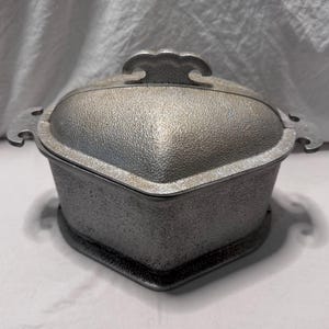 May include: A set of three ceramic mugs with a speckled, matte finish. The mugs are in shades of cream, light gray, and dark gray. Each mug has a simple, minimalist design and a rounded handle.