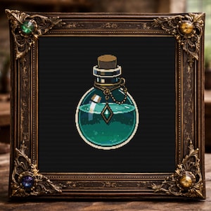 May include: A framed cross-stitch of a potion bottle with a cork stopper, filled with green liquid and a diamond-shaped gem. The ornate, dark brown frame has decorative corners and is set against a dark background.