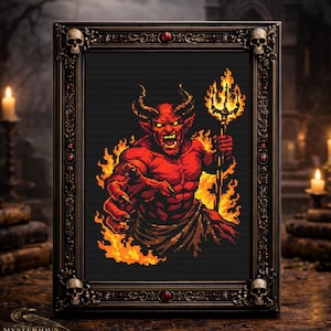 May include: Framed cross-stitch art featuring a red devil with horns, holding a trident and surrounded by flames. The artwork is set against a black background within a decorative, ornate frame with skull accents. The text "MYSTERIOUS RAVEN" is at the bottom.