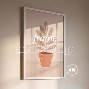 May include: White framed art print featuring a plant illustration in a terracotta pot. The artwork has a neutral color palette with the words "frame mockup" in white. The image is labeled "4K High Quality 4000x4000 px 300 DPI".