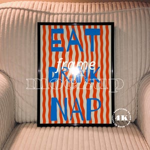 May include: A framed art print with the words "EAT DRINK NAP" in blue and white text. The background features vertical red and white stripes. The frame is black.
