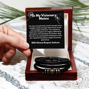 May include: A black braided leather bracelet with a magnetic clasp featuring the engraved text love you forever and a central metal bead, presented in a dark wood box with a card that reads To My Visionary Mateo and includes a message of respect.