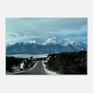 May include: A set of three ceramic mugs with a speckled, matte finish. The mugs are in cream, light grey, and dark grey. Each mug has a simple, minimalist design, ideal for coffee or tea.