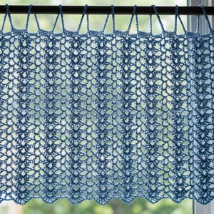 May include: A light blue crochet curtain featuring an intricate openwork pattern with vertical columns of repeating floral-like motifs. The top edge is finished with a series of evenly spaced loops designed to slide onto a curtain rod for hanging.