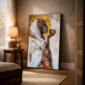 May include: A framed art print depicts a woman in profile holding a cup of coffee. The artwork features a gold background and a collage-style design with geometric patterns and warm colors. The woman wears a white head covering.