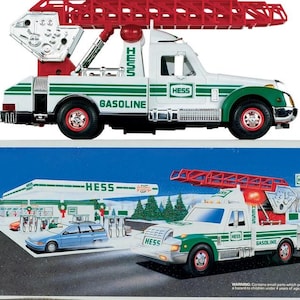 May include: A white ceramic mug with a black handle and the text "But First, Coffee" in a black, handwritten-style font. The mug is on a white surface.