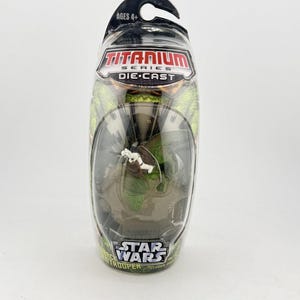 May include: A Star Wars Titanium Series die-cast toy figure of a Biker Scout Trooper in a clear plastic package. The package includes the text "AGES 4+" and the Star Wars logo.