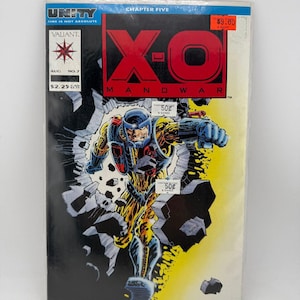 May include: A Valiant comic book titled X-O Manowar, Chapter Five, Unity, number 7, dated August. The cover features a character in a yellow and blue armored suit bursting through a black wall. The text includes Unity, Time Is Not Absolute, Valiant, X-O Manowar, and price markings.