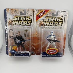 May include: Two Star Wars action figure packs. One features Anakin Skywalker, the other a Clone Trooper Lieutenant. Both figures are in clear plastic packaging with the Star Wars logo and text.